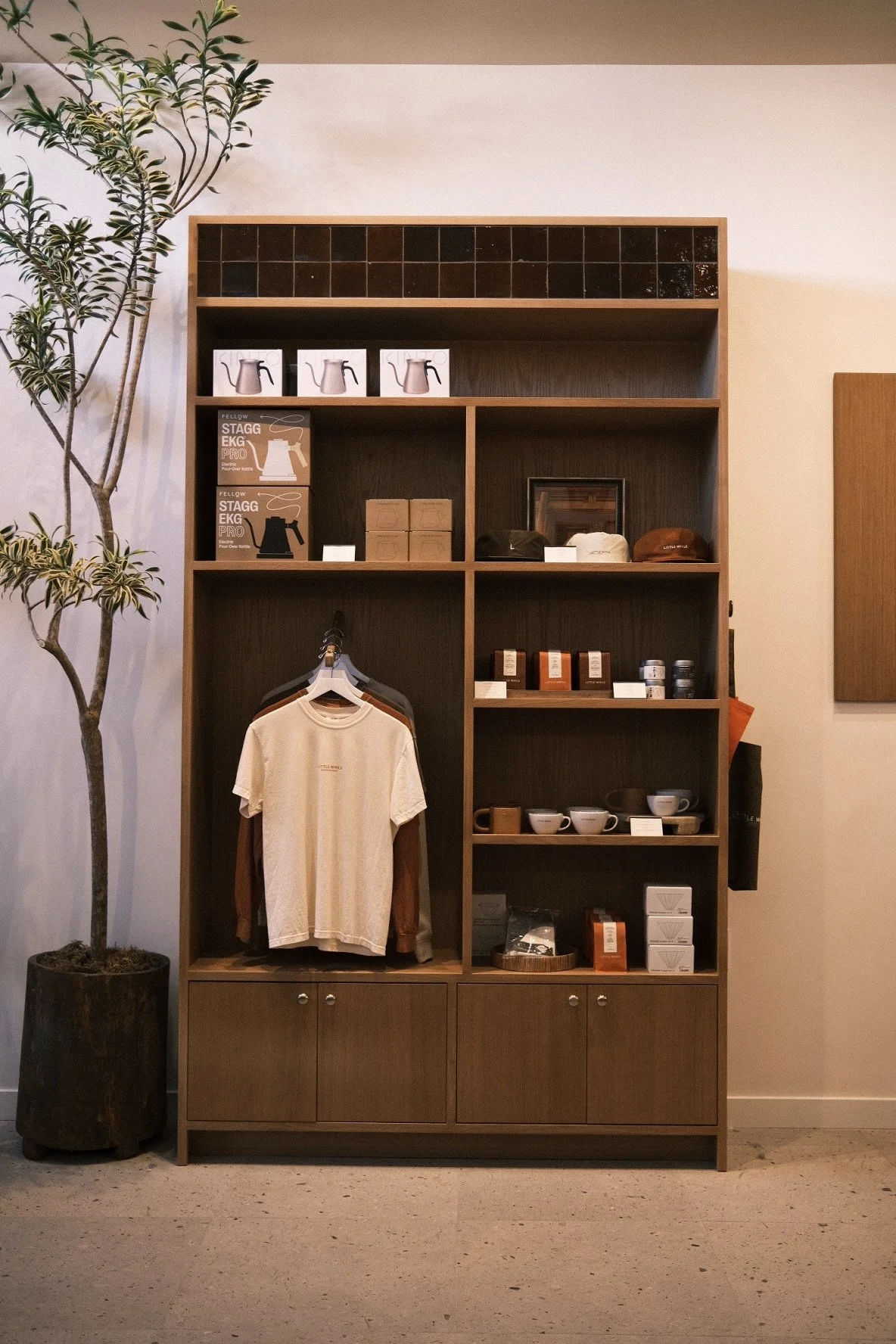 White oak merchandise casework with hanging rail and display shelving at Little While, North Park, San Diego