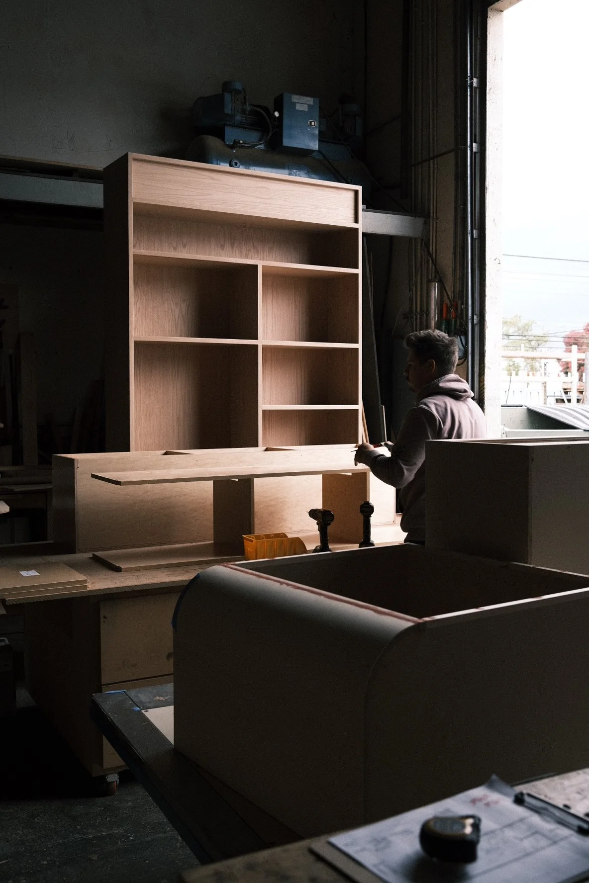 White oak open shelving and merchandise casework in fabrication in the PhillBuilt shop