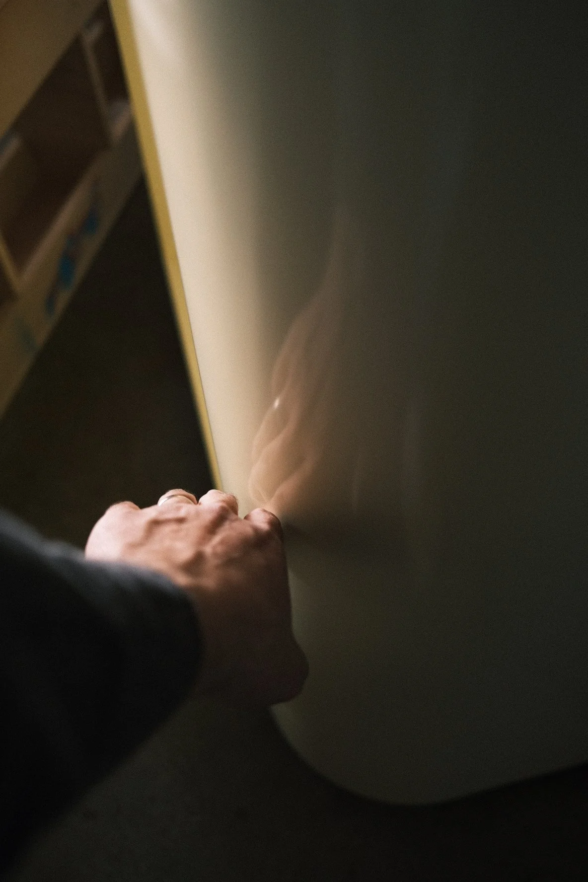 Hand-sanding a curved white oak panel in the shop