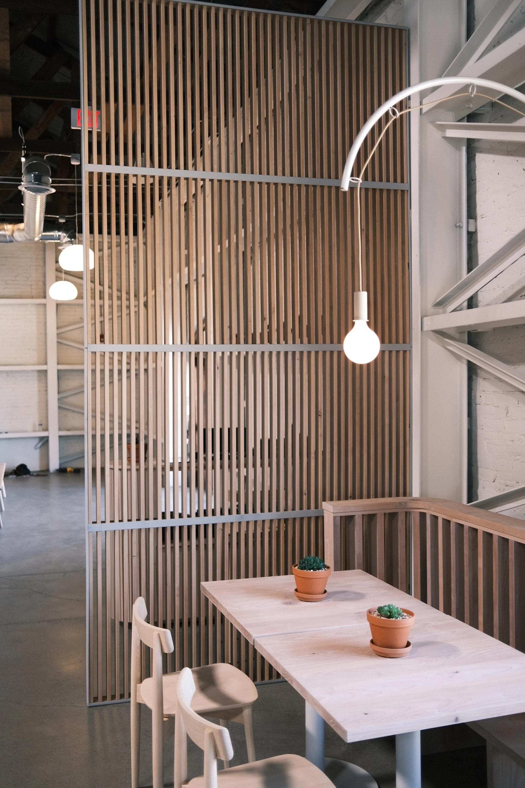 Vertical white oak slat screen wall with café seating at Slow and Low, Elk Grove