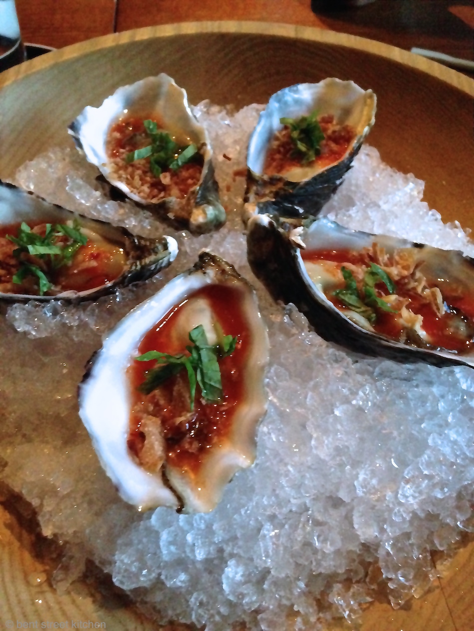 shucked oyster with lime, chilli nam jim & crispy shallots