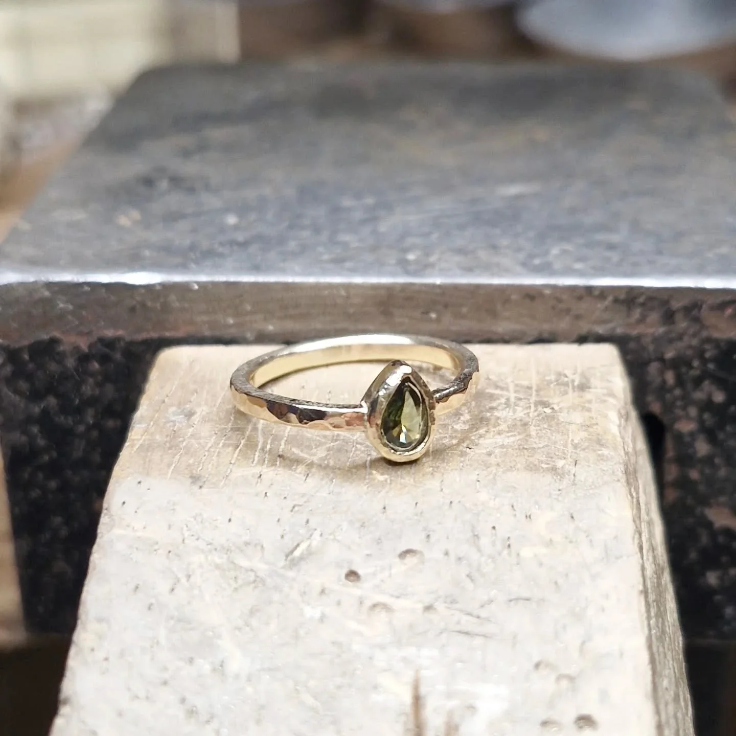 SAPPHIRE
A lovely, unique wedding ring recently completed. Green sapphire in a 9ct organic band with my ocean style hammered textures.