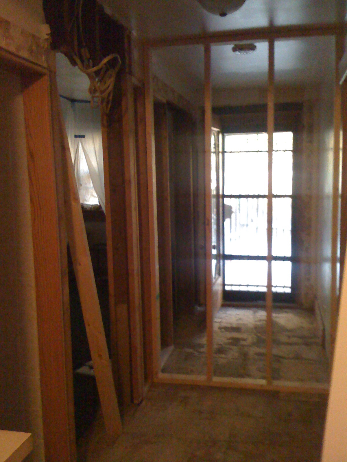 View from the hall. New closet framing and entry door to bedroom. Notice another door to the left (tiled wall), which was the original entrance to the bathroom, that we closed off.
