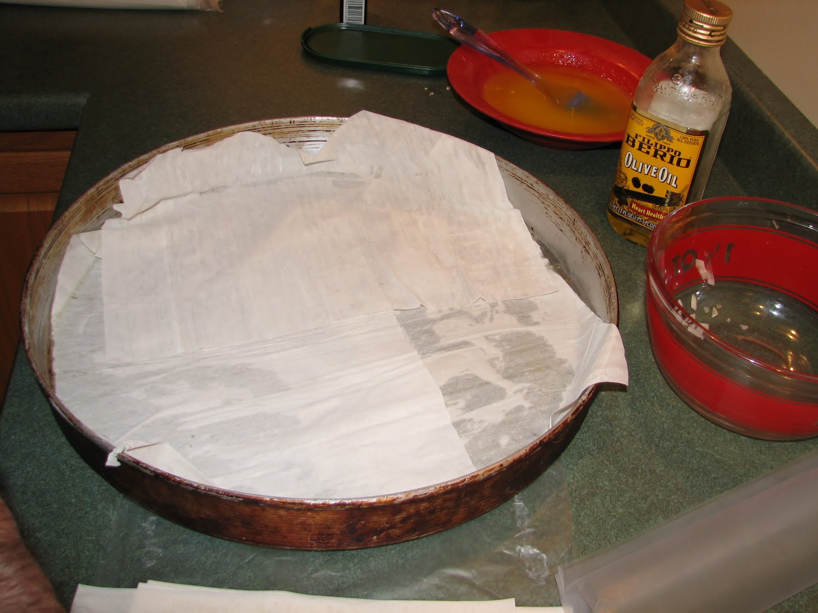   This is Bill's special pan for making a giant kotopita pie. You can buy one in the Immigrant Kitchens store [link to product page], or simply make more than one pie in smaller baking dishes that you already have. Use butter or olive oil to butter t