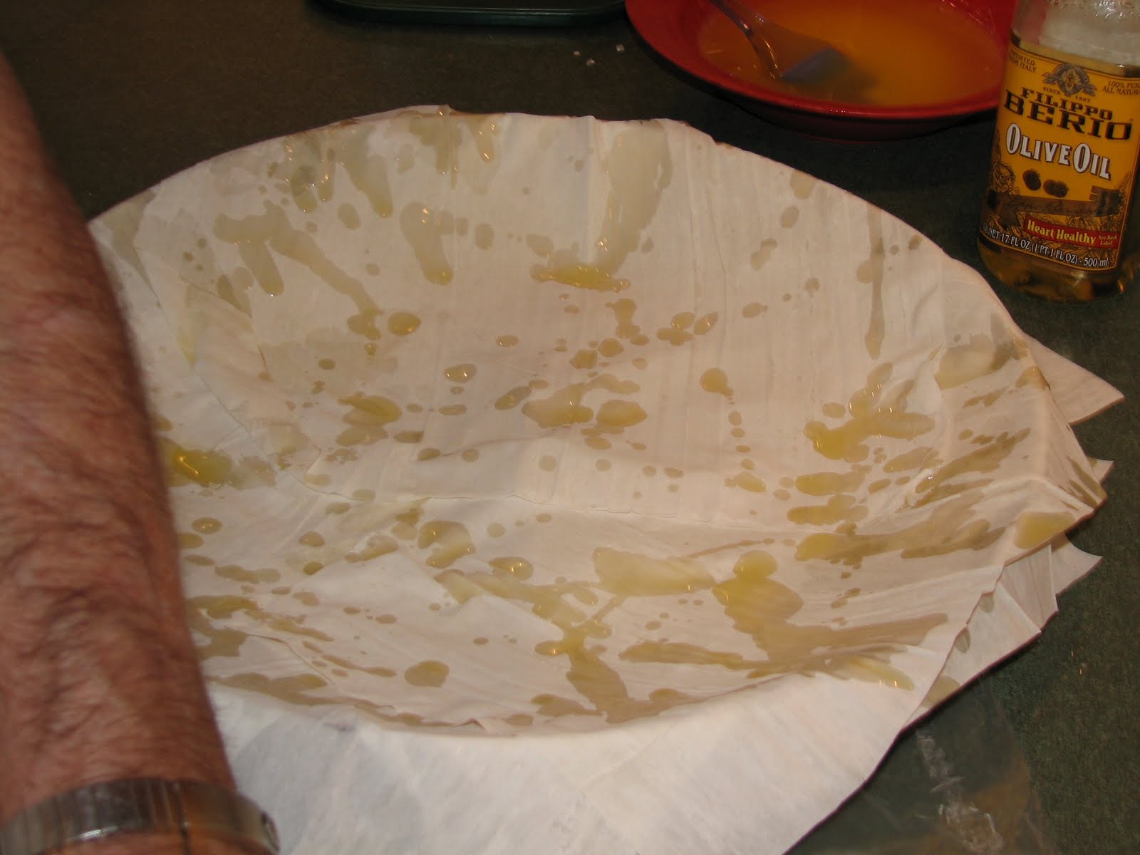   You make five layers of phyllo (butter in between each) before adding half the filling.&nbsp;Then you add two more layers of phyllo. Then the other half of the filling. And then you add five more layers to finish the top of the pie.  