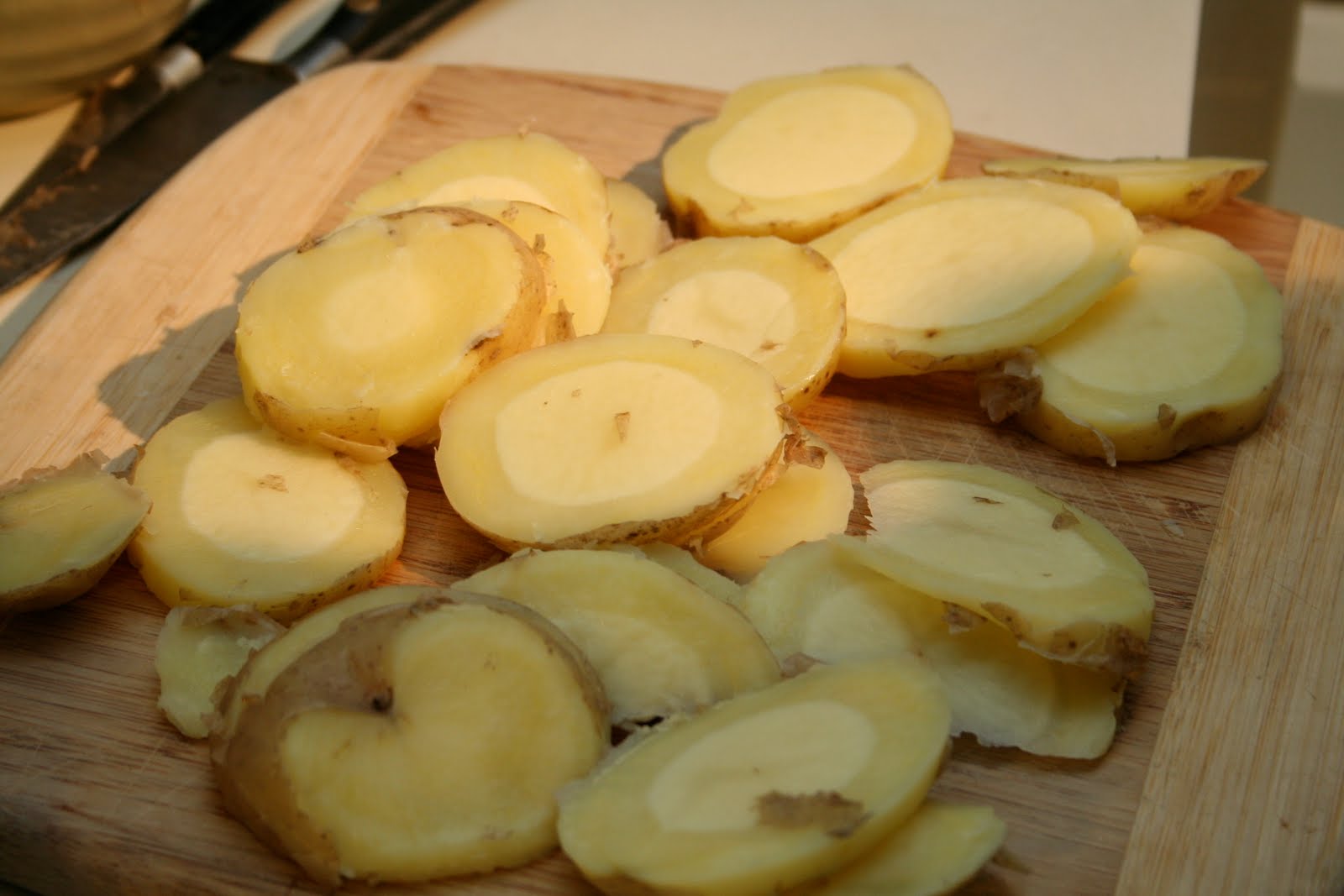   You boil whole potatoes for five minutes so that they're half cooked, and then slice them like this (notice the insides are still raw). You're going to finish cooking them in a saute pan.  