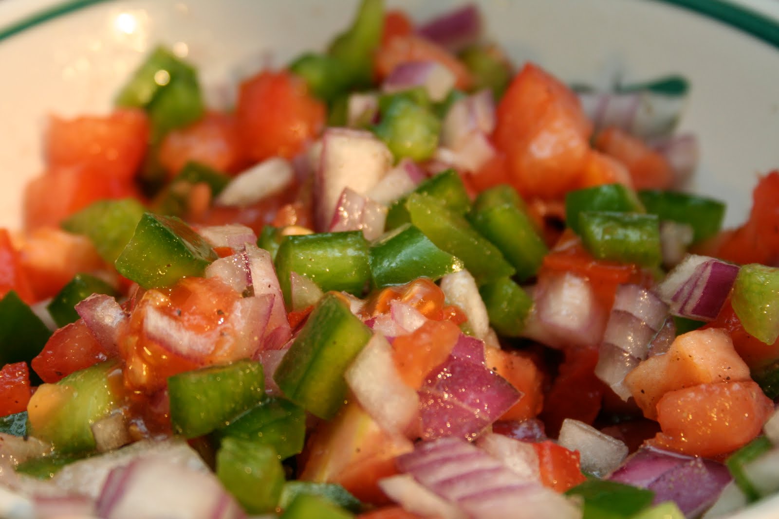  You top the dish with the salad of tomato, red onion, and green pepper. Bright, fresh, and crunchy, it breaks up the richness of the meat, eggs and potatoes. The dressing is equal parts vinegar and oil, plus generous salt.  