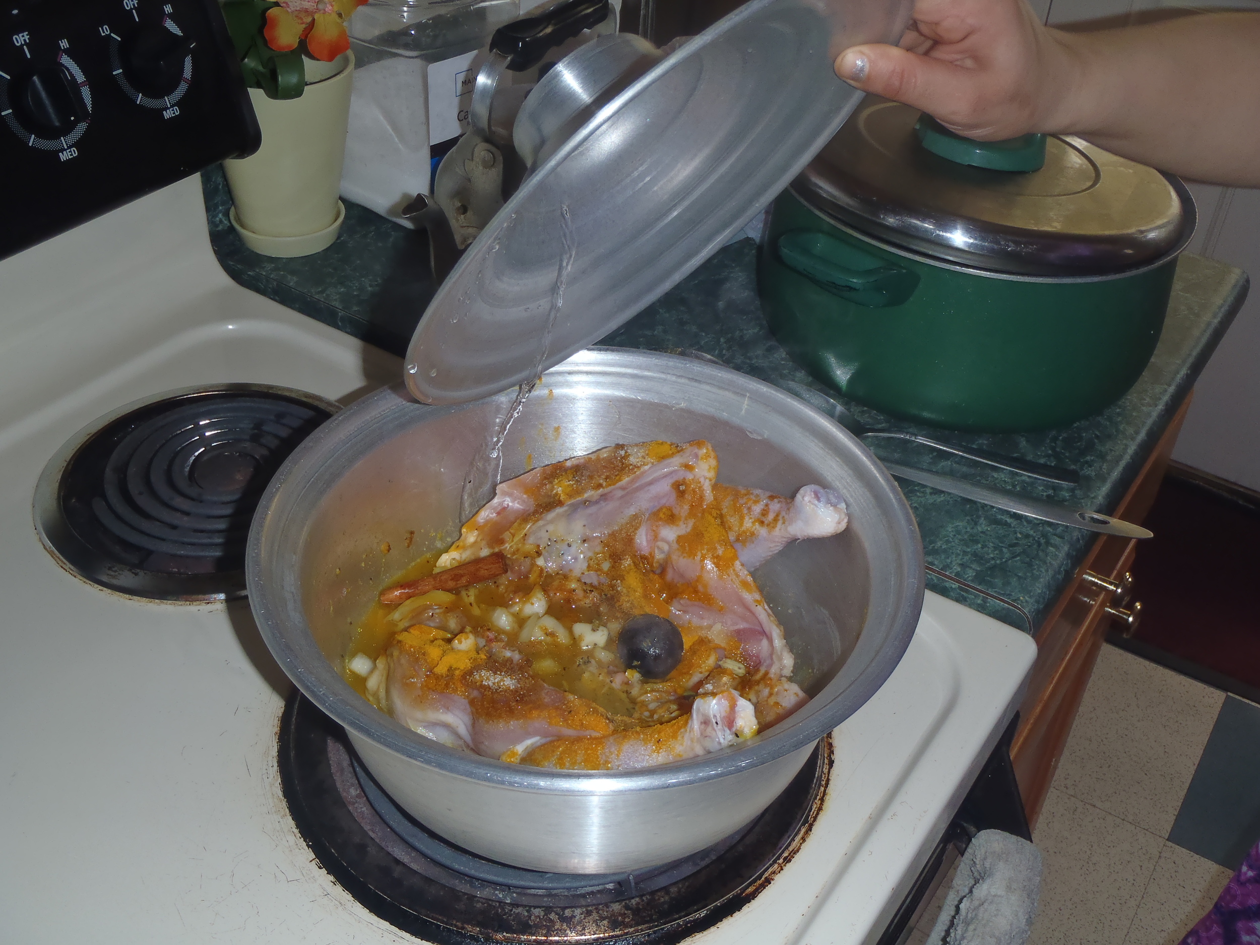  Cook the chicken with lots of spices, including dried Persian lime (the black ball in the center) and turmeric. 