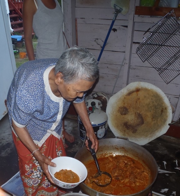 Makara's mother serving a bowl of her Cambodian curry stew