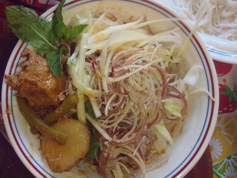 The stew is topped with fresh mung bean sprouts, mint and shaved banana flower.