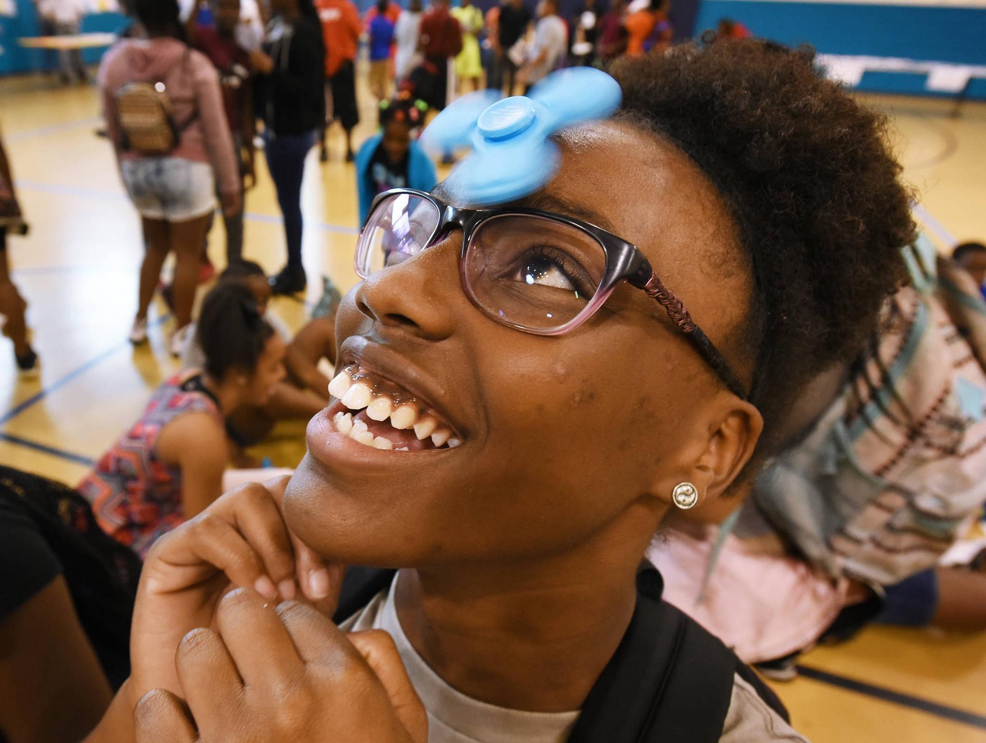 NFL YET Boys & Girls Club member Maya Stephens, 14, balances her fidget spinner effortlessly on her forehead.