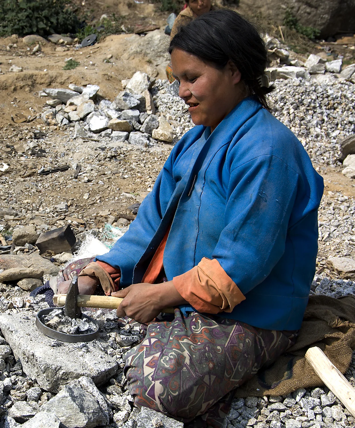 BREAKING ROCKS FOR ROAD BUILDING