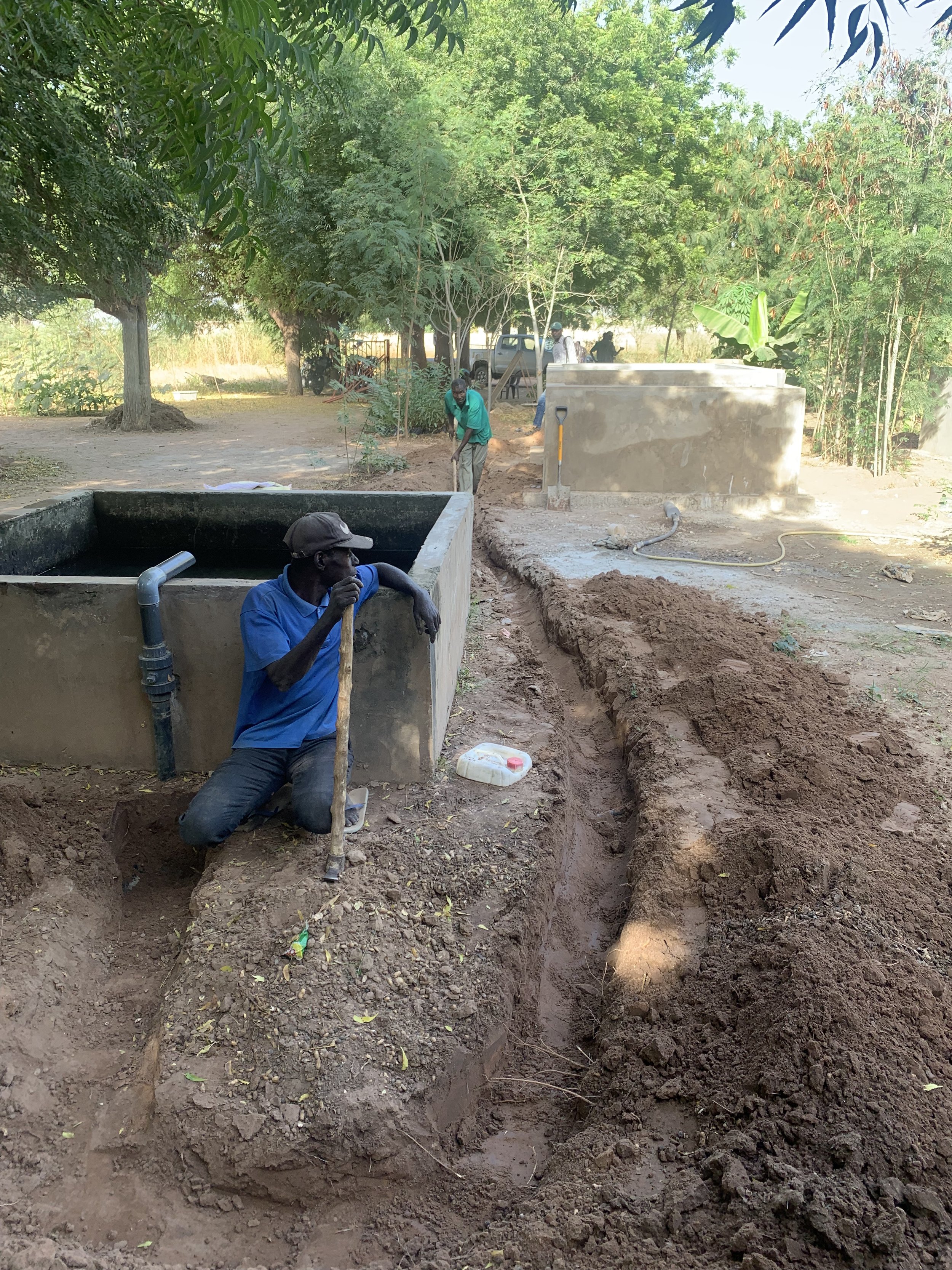 Digging the pipline that will take water from the fish basin to the garden watering basin.