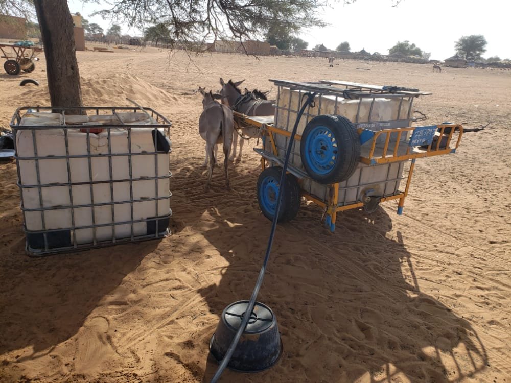 Water for mixing concrete has to be brought in by donkey cart until the site can be plumbed.  