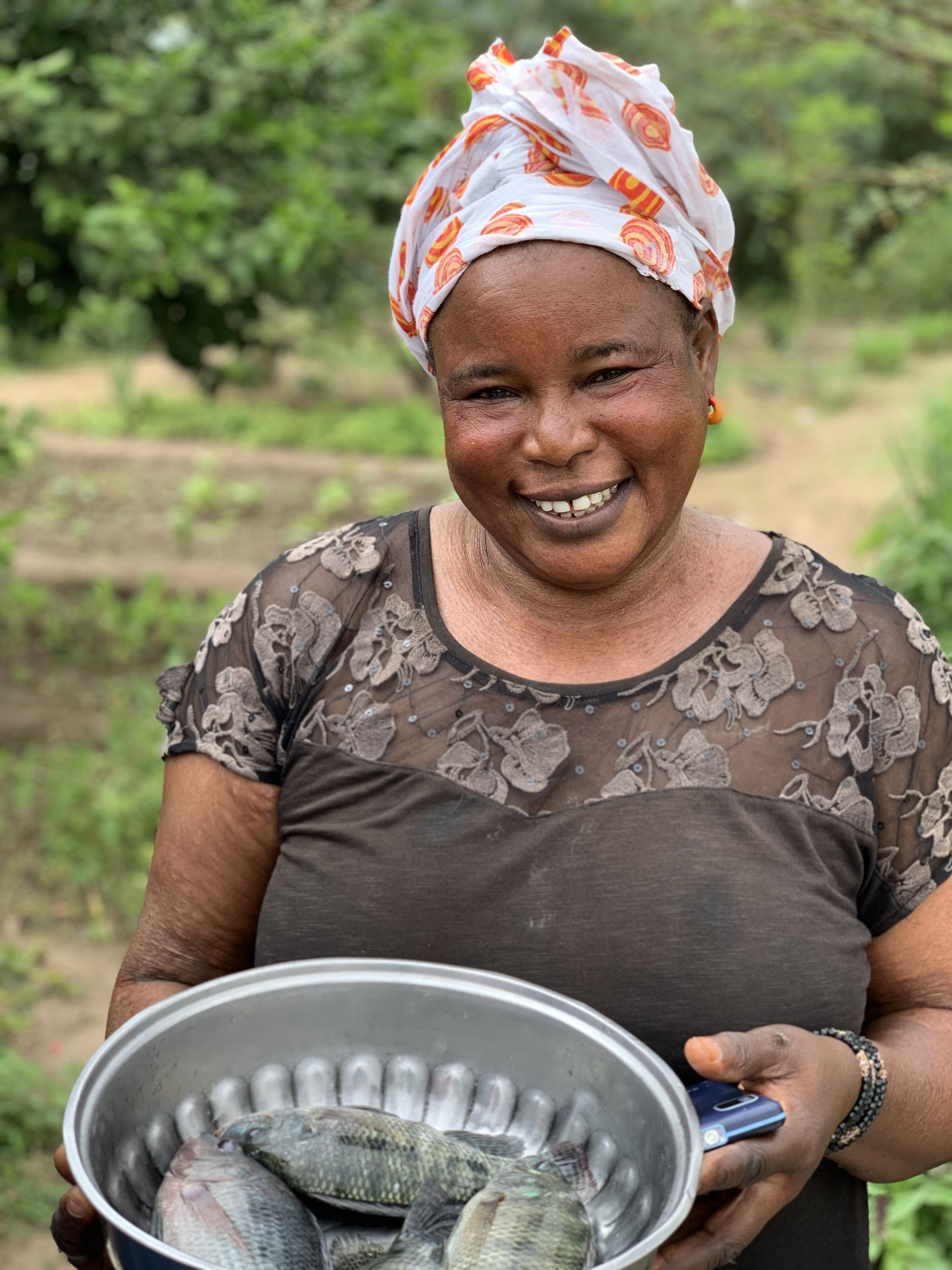 17_Keur Wack garden member with her fish harvest.JPEG