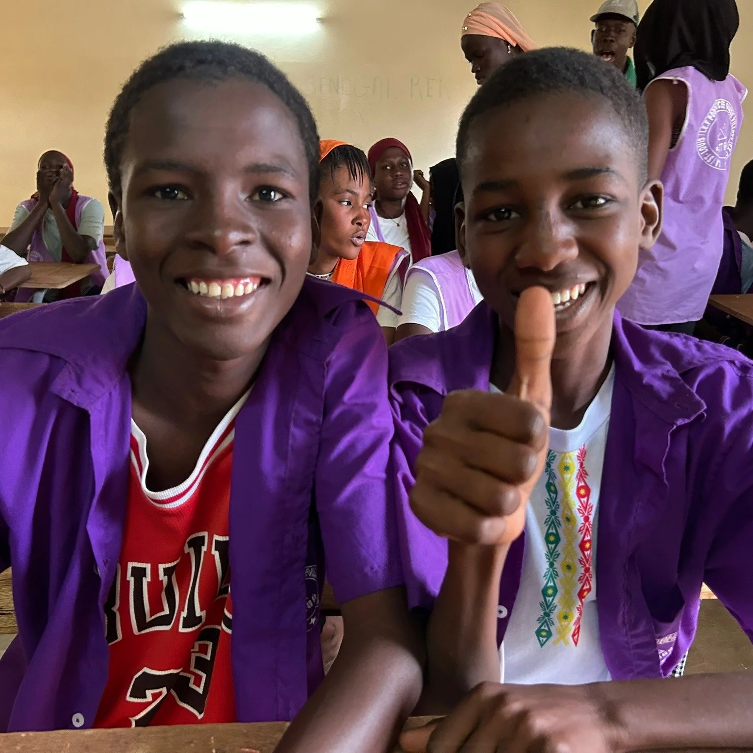 A big thumbs up from students at Gu&eacute;d&eacute; Village High School for the recent improvements at their school.  Students and teachers here have faced inadequate facilities, creating major barriers to education. But with your support, we constr