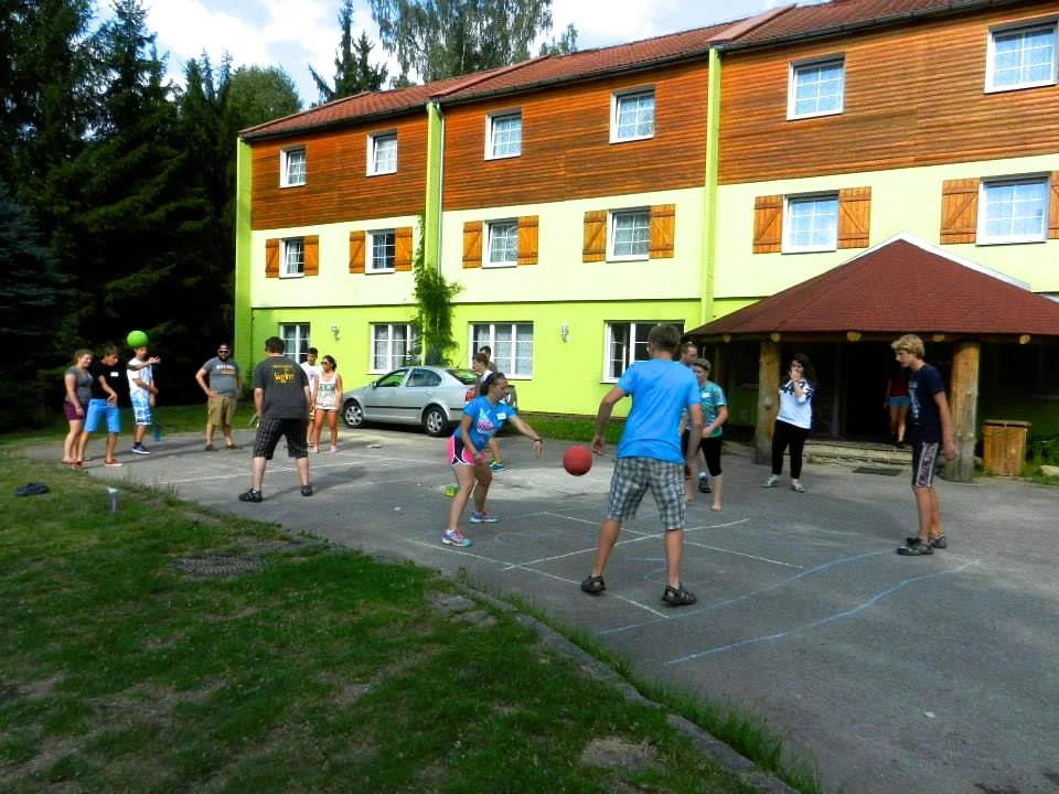 Waiting on the stairs for dinner (Left) and playing a game called “4 Square” afterwards (Above)