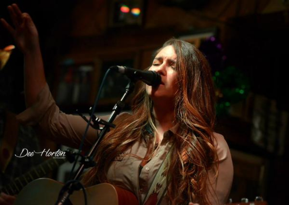 CHRISTINA CHRISTIAN PERDIDO KEY, FL Born and raised in South Alabama, Americana/Country Singer-Songwriter, Christina Christian is in it for the long haul. For the past 5 years, Christina has traveled the Southeast, mainly Alabama, Mississippi, Tennessee, Georgia, and Florida to perform her music. The 22 year old currently lives in Perdido Key, Florida entertaining her home base along the the Gulf Coast. Christina Christian got her foot in the door with music at young age, 8 years old to be exact. Her Father was a classic rock kind of guy, who always played guitar, and her Mother listened to Country. Christian was influenced tremendously by all sorts of music, which led to being creative with words and the first three chords on her decorated Johnson guitar. In Middle school, she wrote poetry, and kept writing all the way into high school until her independent studies class gave her the freedom to learn more about Songwriting. She picked up guitar at the age of 16, after taking a shot at her high school talent show her sophomore year. Originally, Christina wanted the college life. She had the dream of becoming a Sports Medicine Trainer for Football (Roll Tide) But, there are some things you can't deny, and that was her love for music. So, taking a few steps forward, Christina ended up with 6 scholarships to pay her way through college at Troy University. She decided a Music Industry degree was the path for her. Christina's first day in college was a day that changed her life forever. Her professor was the real deal, who worked with Michael Jackson back in the day, MICHAEL JACKSON. She will never forget the first words that came out of Mr. Smith's mouth. "You do not need a degree to be in the music industry." Christina took those words to heart and within the year, she withdrew from college to work in the real world. Since moving back from college at the age of 19, Christina has been a waitress, a pizza slinger, a zip-line guide, and first and foremost, a musician. Between her day jobs in 2013, Christian shared the stage with country stars such as, Maggie Rose, Jana Kramer, Cassadee Pope, Tyler Farr, and The Henningsens with the help of her good friends at 95KSJ. The following year was turning point. Christina began being recognized for her songwriting craft, which led to performing in the Frank Brown International Songwriter's Festival, the Mississippi Songwriters Festival, and the Hwy. 80 Songwriters Festival in Meridian, MS. With the festivals being a major influence on Christina, she took her songwriting to a new level, so she moved to Nashville in the hopes of becoming a big star. Well, scratch that, she actually went Nashville to gain experience in the city. As Christina see's it, Nashville is a great learning tool for co-writing, playing shows for free, and how to cook Ramen Noodles right way. So now, she performs regularly at the World Famous Flora-Bama Lounge & Package, Happy Harbor, Moe's Original BBQ, Bella Luna and many more venues on the Gulf Coast. Christina Christian got her foot in the door with music at young age, 8 years old to be exact. Her Father was a classic rock kind of guy, who always played guitar, and her Mother listened to Country. Christian was influenced tremendously by all sorts of music, which led to being creative with words and the first three chords on her decorated Johnson guitar. In Middle school, she wrote poetry, and kept writing all the way into high school until her independent studies class gave her the freedom to learn more about Songwriting. She picked up guitar at the age of 16, after taking a shot at her high school talent show her sophomore year. Originally, Christina wanted the college life. She had the dream of becoming a Sports Medicine Trainer for Football (Roll Tide) But, there are some things you can't deny, and that was her love for music. So, taking a few steps forward, Christina ended up with 6 scholarships to pay her way through college at Troy University. She decided a Music Industry degree was the path for her. Christina's first day in college was a day that changed her life forever. Her professor was the real deal, who worked with Michael Jackson back in the day, MICHAEL JACKSON. She will never forget the first words that came out of Mr. Smith's mouth. "You do not need a degree to be in the music industry." Christina took those words to heart and within the year, she withdrew from college to work in the real world. Since moving back from college at the age of 19, Christina has been a waitress, a pizza slinger, a zip-line guide, and first and foremost, a musician. Between her day jobs in 2013, Christian shared the stage with country stars such as, Maggie Rose, Jana Kramer, Cassadee Pope, Tyler Farr, and The Henningsens with the help of her good friends at 95KSJ. The following year was turning point. Christina began being recognized for her songwriting craft, which led to performing in the Frank Brown International Songwriter's Festival, the Mississippi Songwriters Festival, and the Hwy. 80 Songwriters Festival in Meridian, MS. With the festivals being a major influence on Christina, she took her songwriting to a new level, so she moved to Nashville in the hopes of becoming a big star. Well, scratch that, she actually went Nashville to gain experience in the city. As Christina see's it, Nashville is a great learning tool for co-writing, playing shows for free, and how to cook Ramen Noodles right way. So now, she performs regularly at the World Famous Flora-Bama Lounge & Package, Happy Harbor, Moe's Original BBQ, Bella Luna and many more venues on the Gulf Coast.