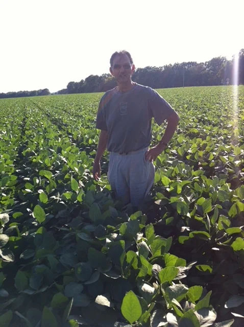  Sam and Jim's dad standing in a field of soybeans. 