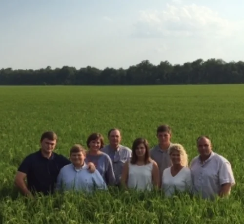 Sam, Alicia, Jim, Leslie and their children in one of their beautiful rice fields.