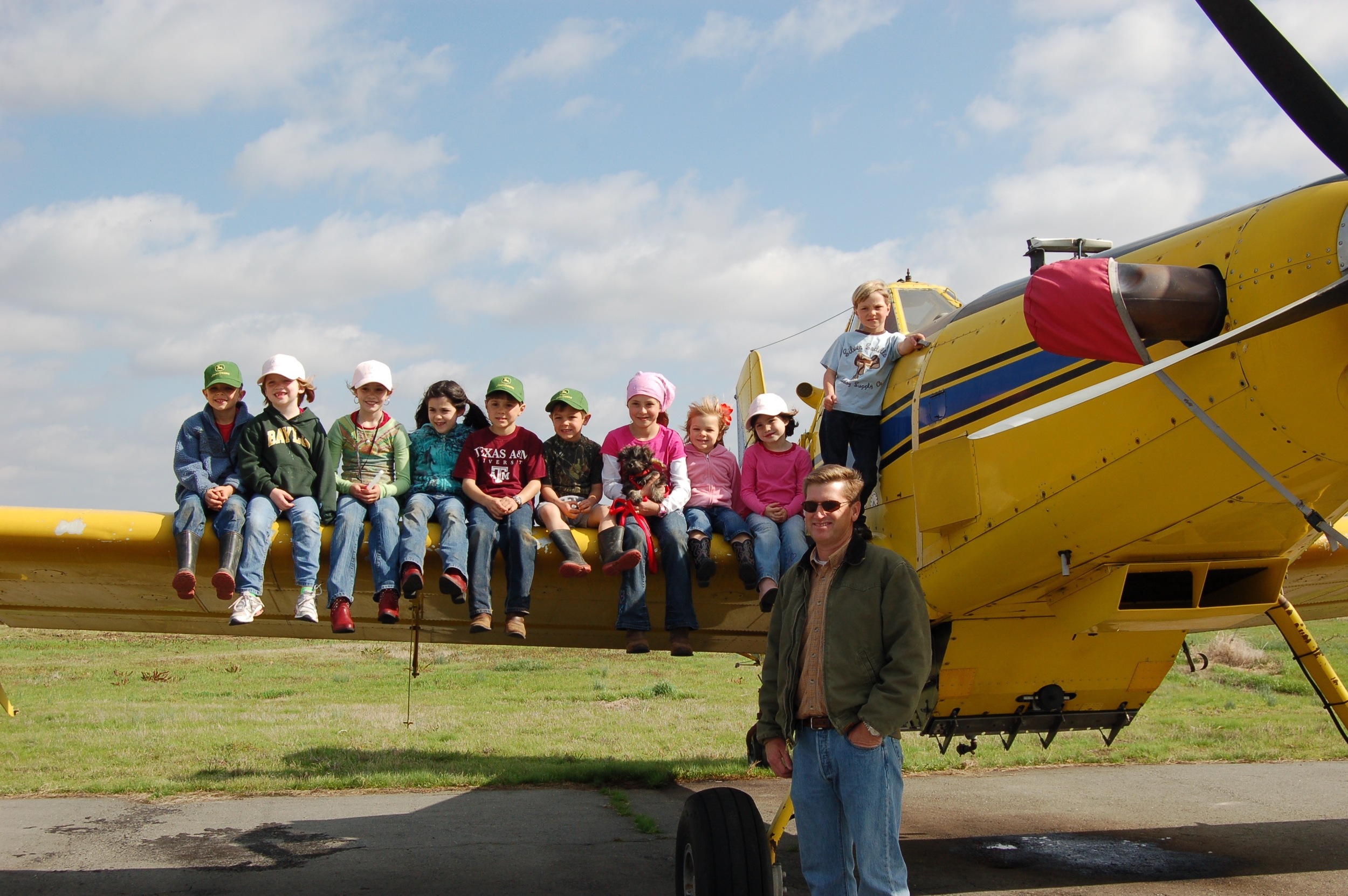 friends learning about ag airplanes at the rural airport