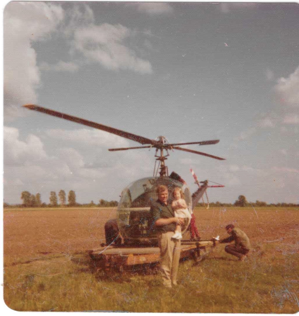 my dad holding me on our farm