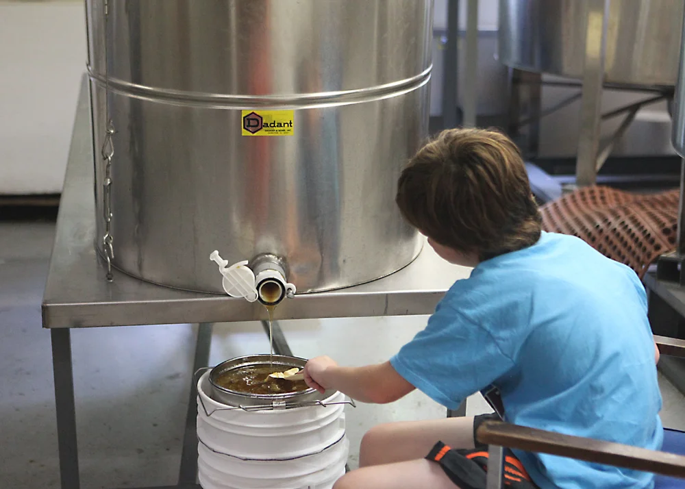 The honey can then flow from the barrel and into a strainer. The strainer offers just enough filtering to remove any stray bee parts that might have made there way into the process. In this process, little to no heat was used and the straining is minimal, so the end product is as raw as possible.