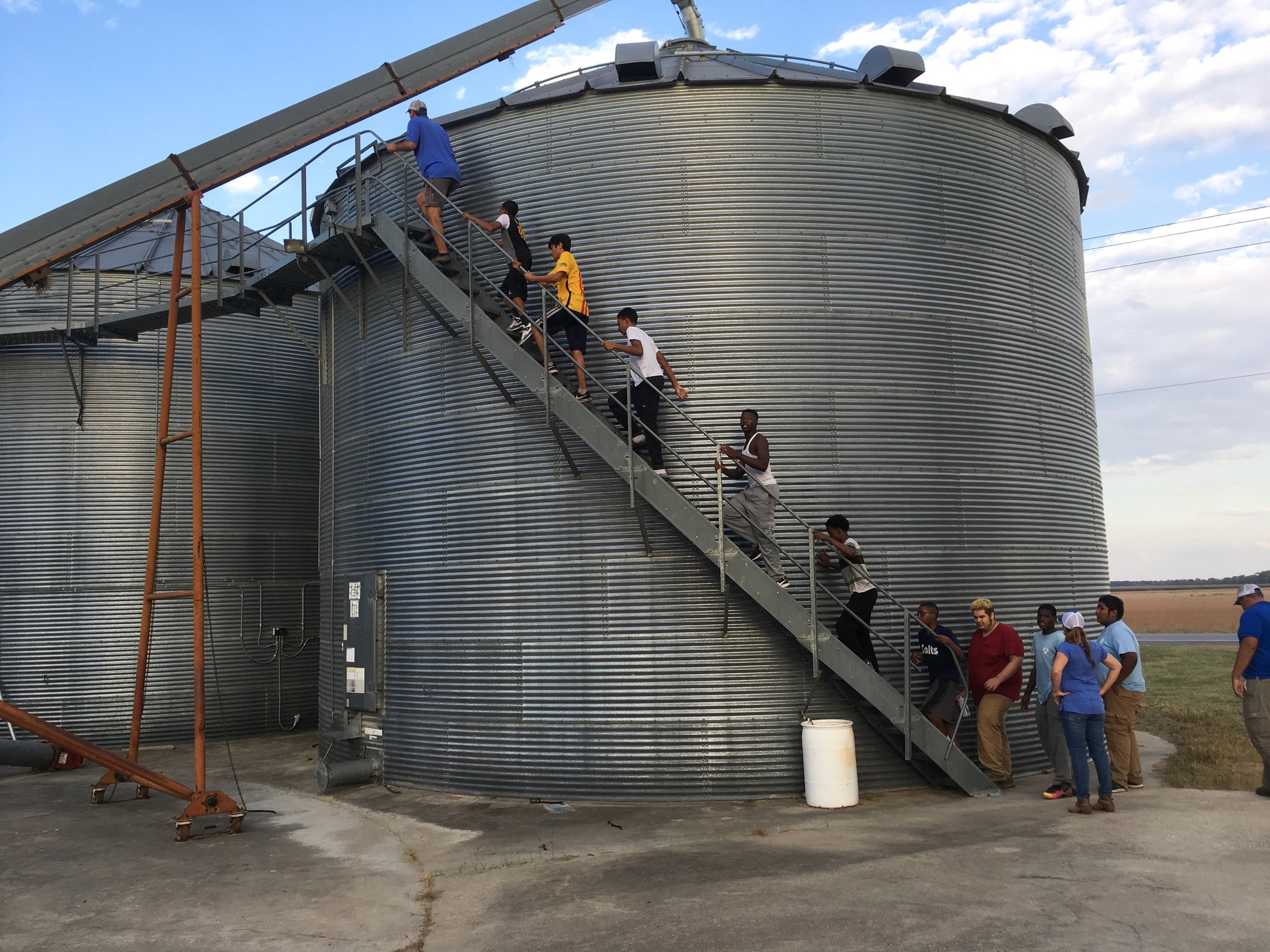 A group from the Mississippi Delta climb to the top of grain bins to see how grain is stored.