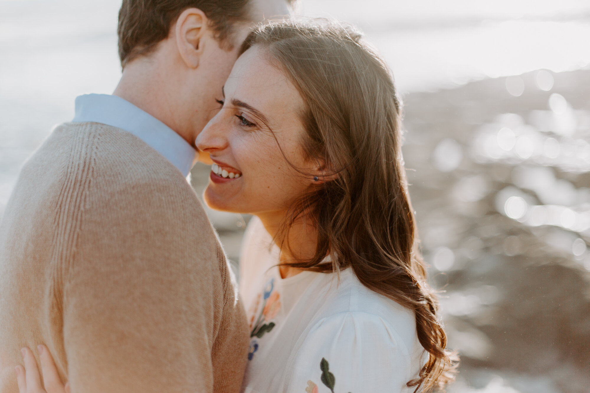 La Jolla Engagement Photos in San Diego with beach cliff and tide pools and on the sand.  Wore a white floral dress and took their engagement photos for their wedding by Kara Reynolds photography