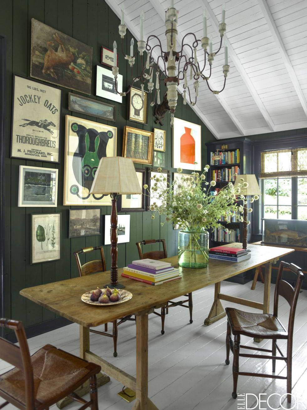 Emery & Cie' s 'Vermoulu 6' deep hunter green provides the perfect backdrop for the couple's collection of art. 