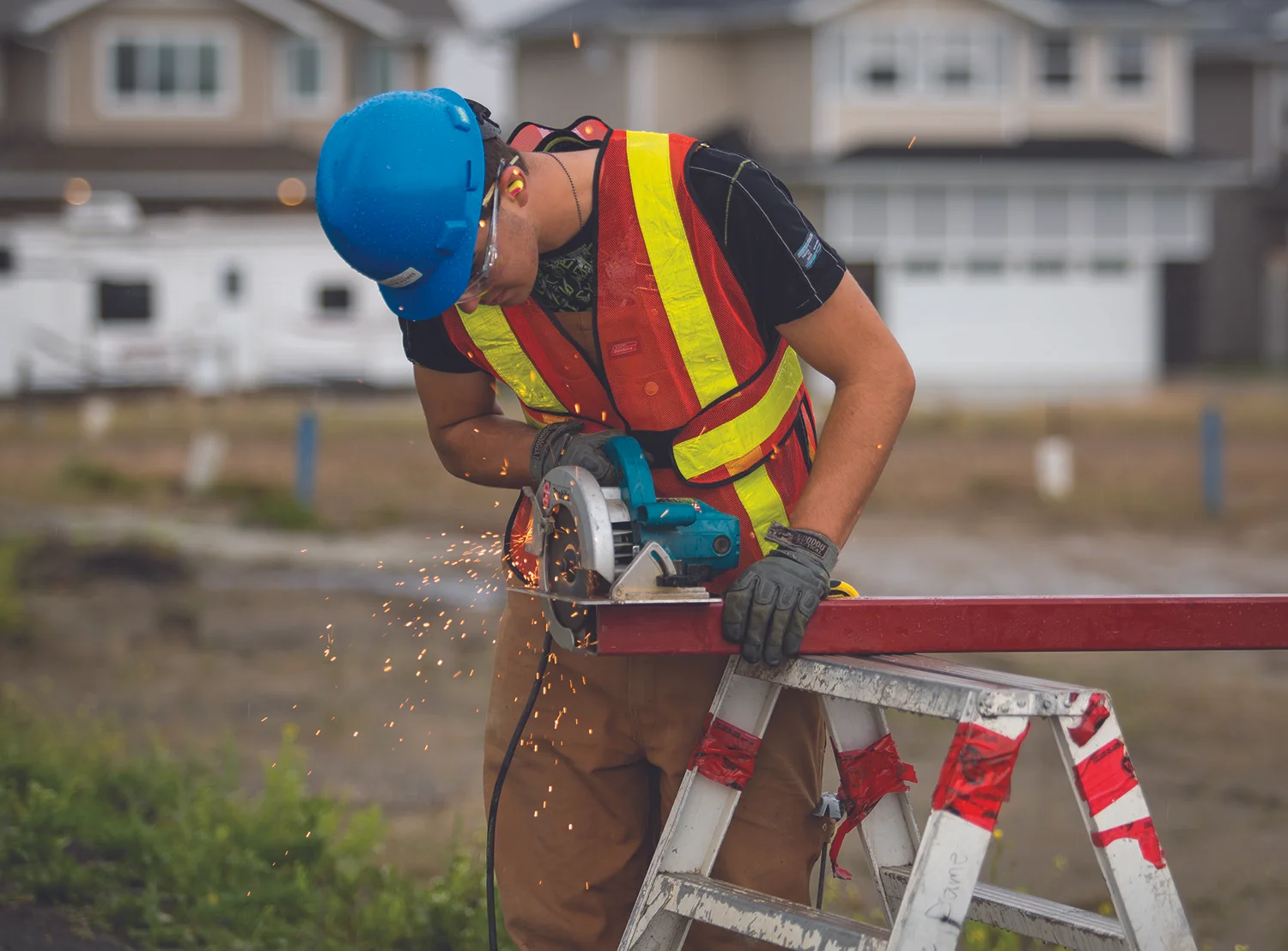 WORKING - A student from École Secondaire Notre Dame High School worked on cutting a piece of metal on the job site as part of the Building Opportunities program in Red Deer on Tuesday, Sept. 20, 2016. The program offers Grade 11 and 12 students from NDHS an opportunity to participate in the construction of a house. — image credit: Zachary Cormier/Red Deer Express