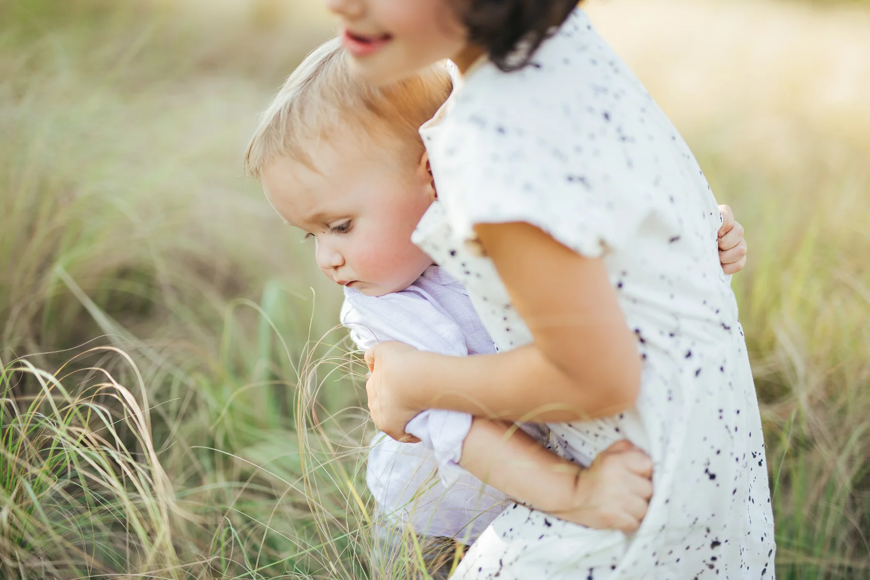 children playing grass family session