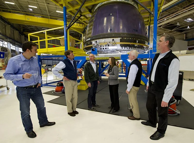 NASA Deputy Administrator Lori Garver, fourth from left meets Blue Origin Founder Jeff Bezos next to Blue Origin's crew capsule along with other Blue Origin team members at the company's headquarters in Kent, WA. Image by Bill Ingalls via Wikimedia Commons