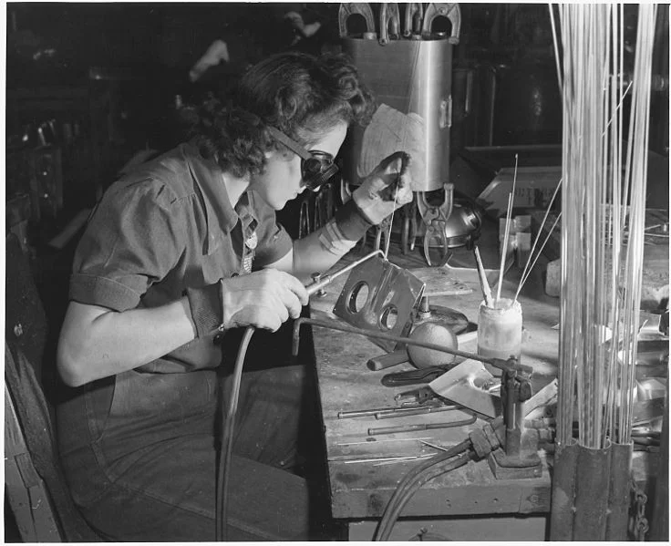 1942: A female welder works on a sub-assembly for a tank used on B-25 bombers. Image via Wikimedia Commons
