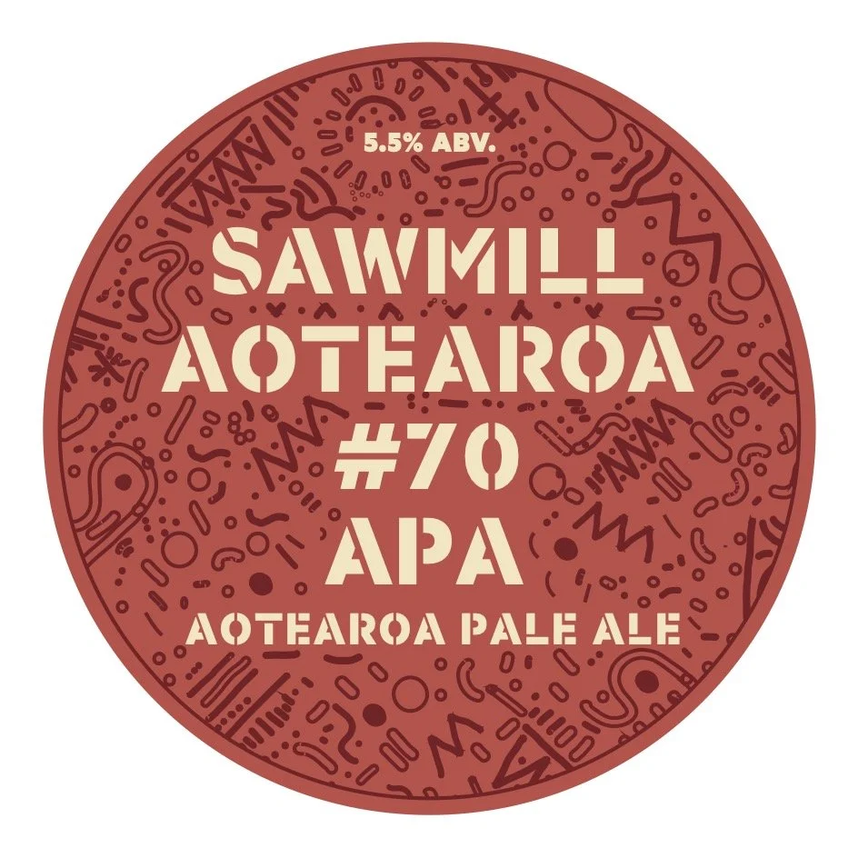 A circular label with a red background and white text promoting a Pale Ale beer named 'Aotearoa Pale Ale' with 5.5% ABV. The label has abstract doodles and patterns in dark red.