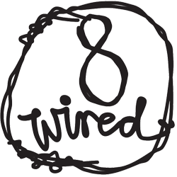 The word 'tired' written in a casual, circular hand-drawn style with a line crossing through it. No additional objects or scenery are visible.