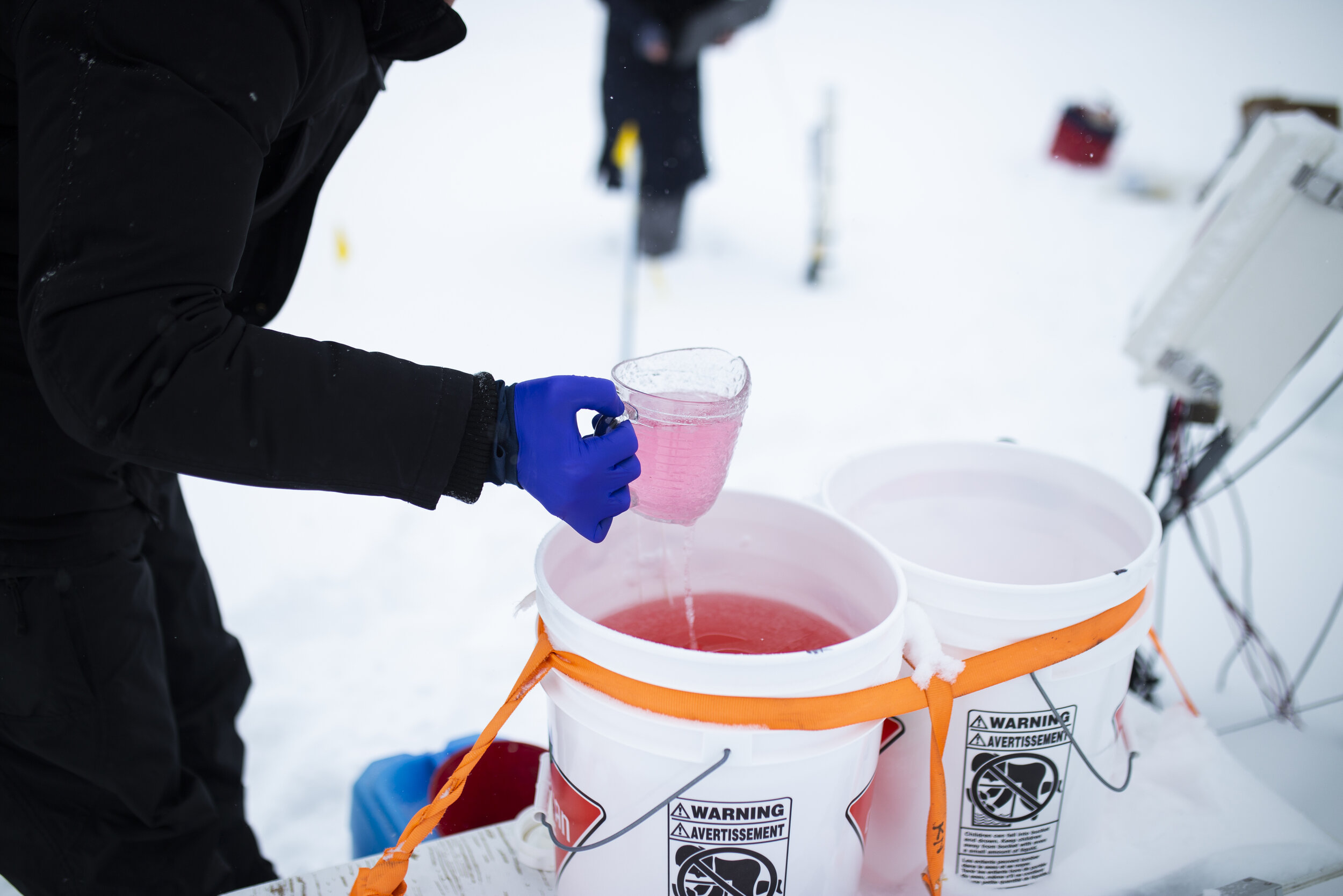  Wright’s assistant and grad student, Mitchell, removes the old anti-freeze solution into a portable container to be properly disposed of off-site so that the research leaves no contamination behind. 