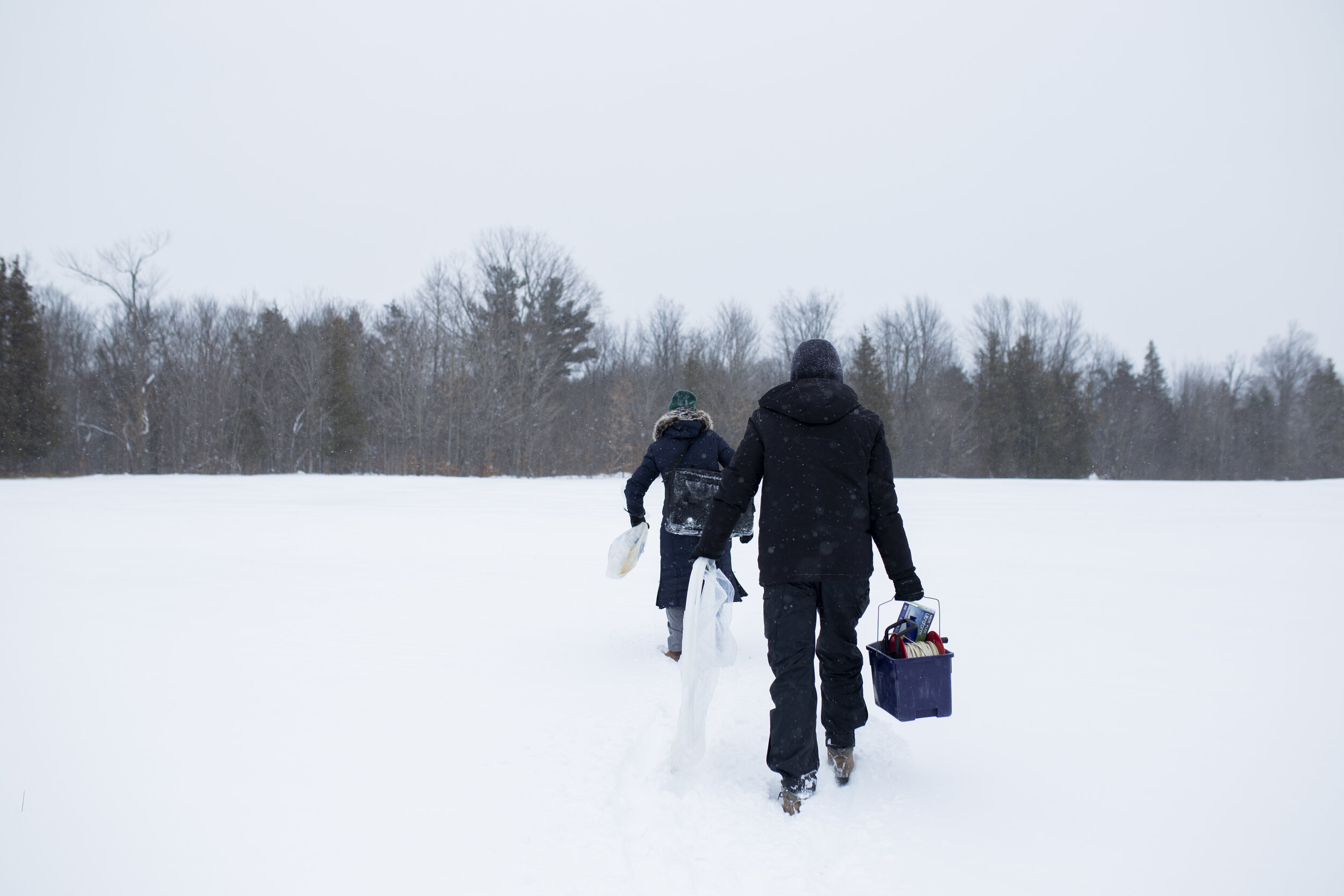  After collecting all her data from the main site, Wright and Mitchell begin trekking an additional 500m in -15ºC and knee deep snow across this field to another part of the site with an additional groundwater well to collect further samples and data