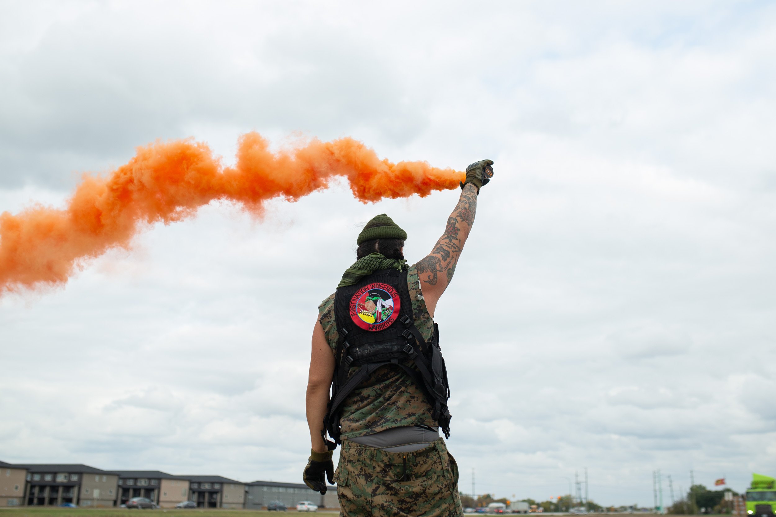  Logan Staats of Six Nations is a First Nations Indigenous Warrior (FNIW) who has visited and stayed at Camp Morgan a couple times, despite living out of province. During one of several road blockades, Staats held an orange smoke bomb. The FNIW are a