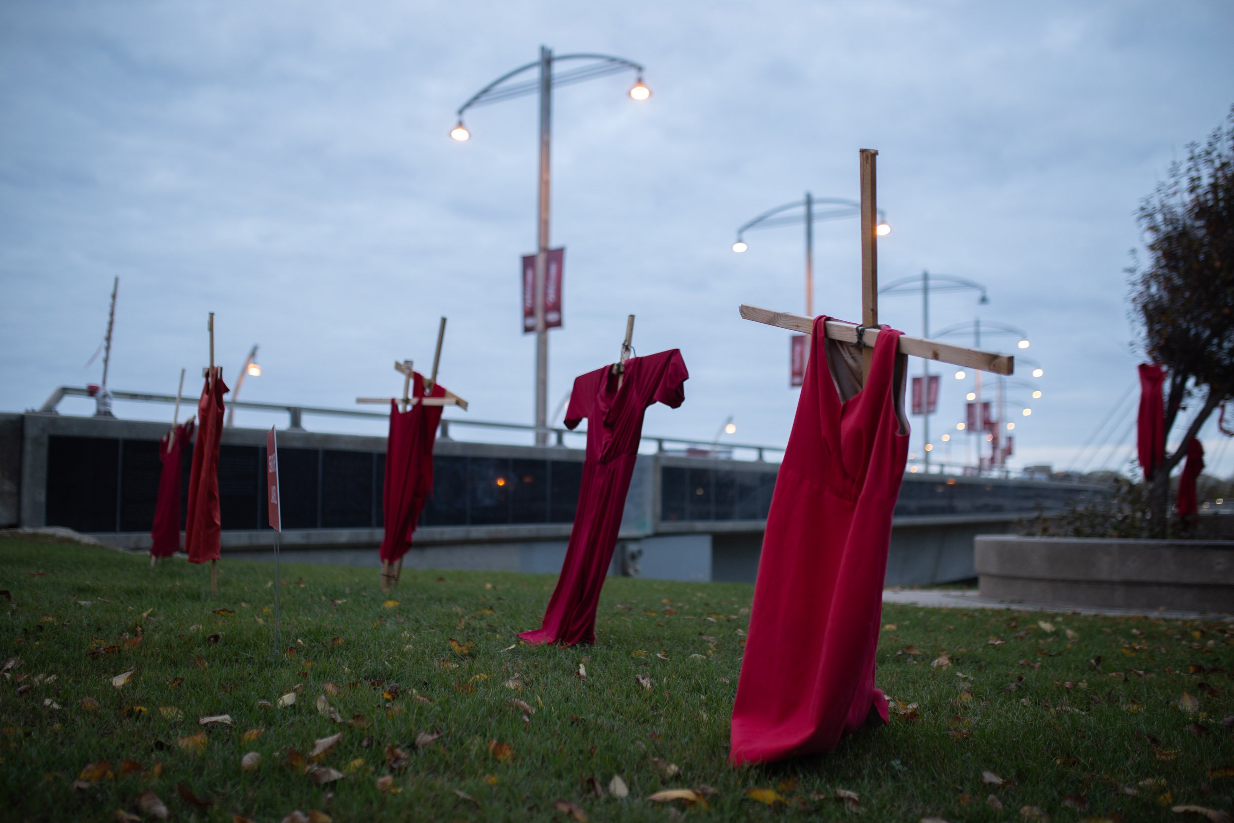  Multiple red dresses, signifying the loss of Indigenous women murdered or missing, are on hung on crosses beside Provencher Bridge and Camp Marcedes in Downtown Winnipeg. 