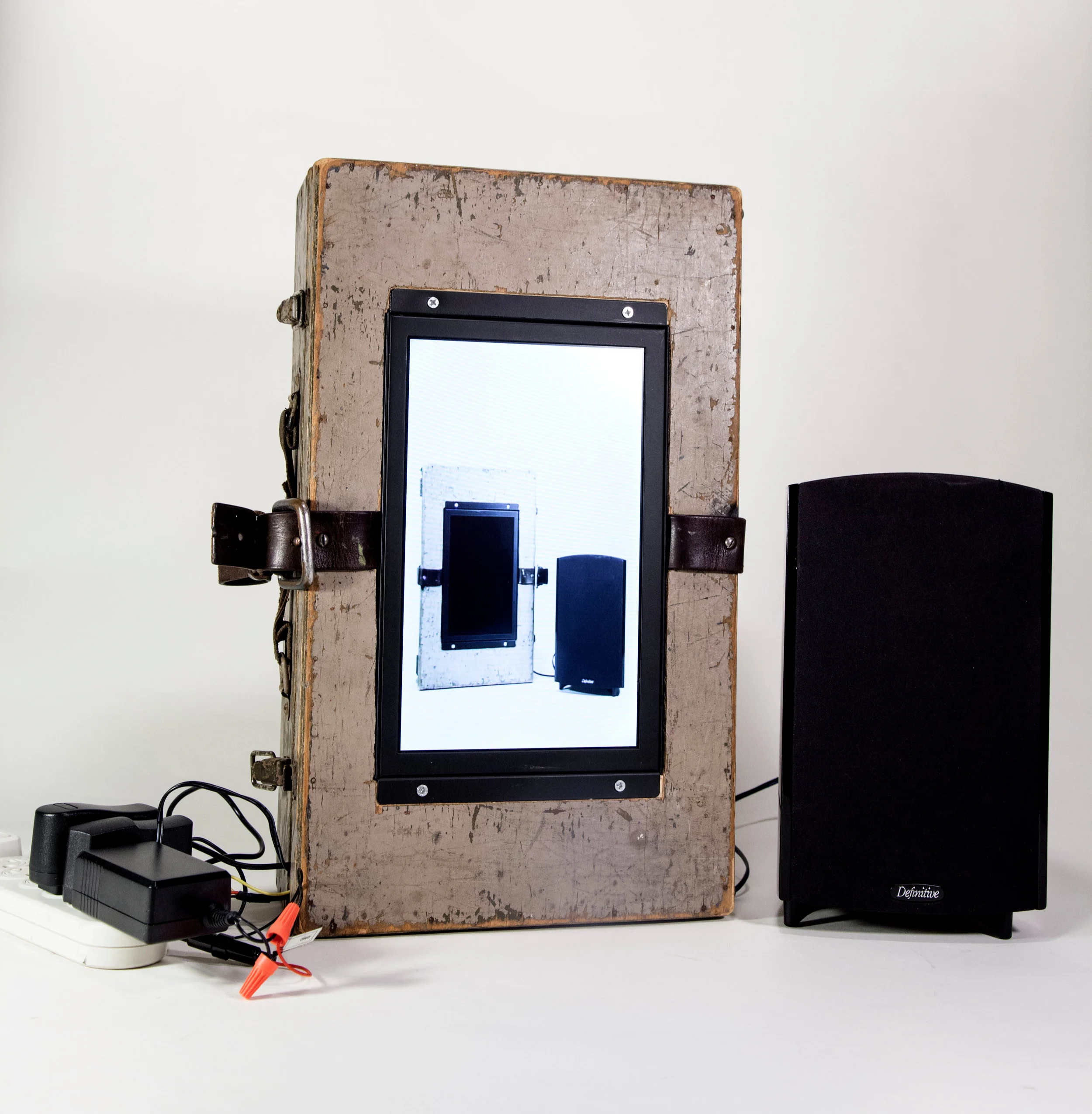 Assistant III | 2017 18” x 18” x 9” Toolbox inherited from grandfather, 11” LCD monitor, worn belt (personal), inherited speaker from father-in-law, SD card media player (purchased off Amazon), RCA to HDMI converter, various cords and DC adapters.