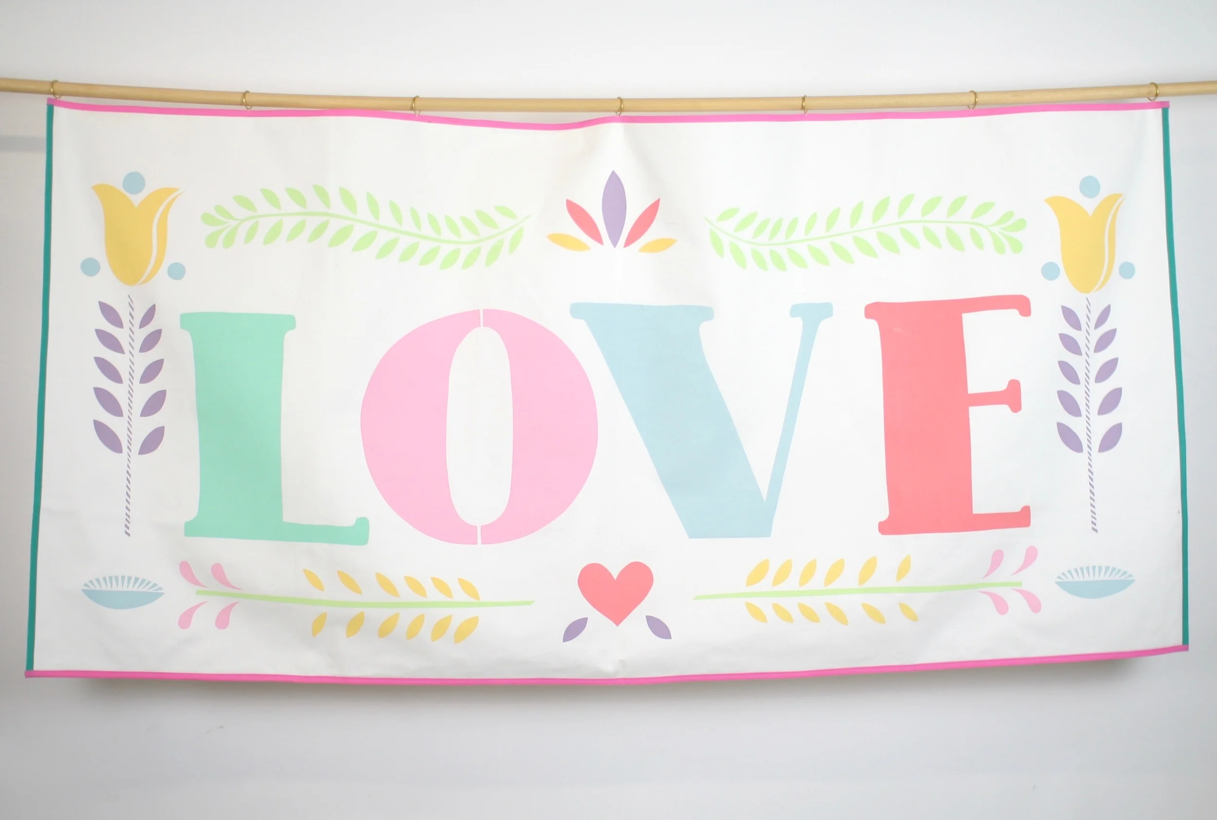 Hand screen printed banner measures 152 cm x 74 cm The banner is backed with the same soft brushed cotton as the front and has seven brass rings for hanging. Trimmed with green and pink ribbon. HIRE: £50 BUY: £150 BESPOKE: Prices from £250