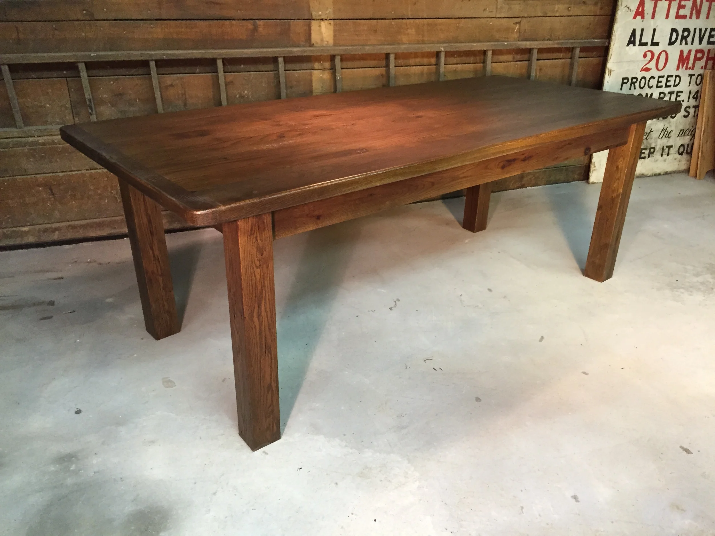 8' thick top dining table with Breadboards, straight legs and a Walnut finish.