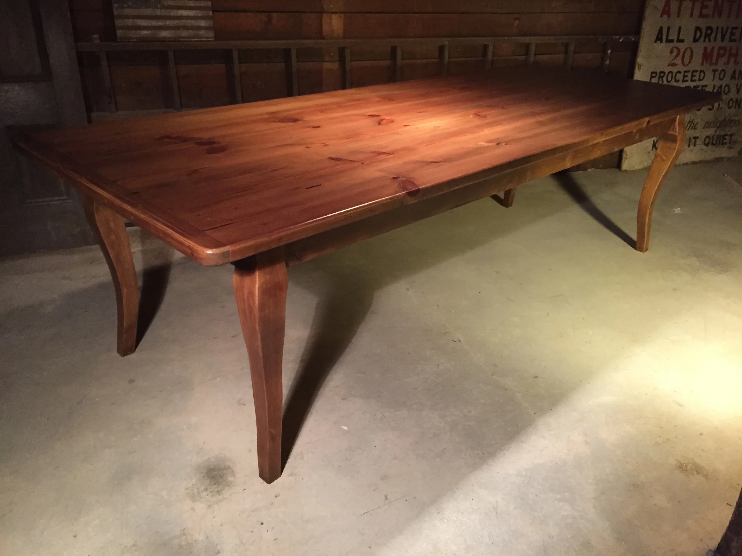8' thick top dining table with cabriolet legs in a Hazelnut finish