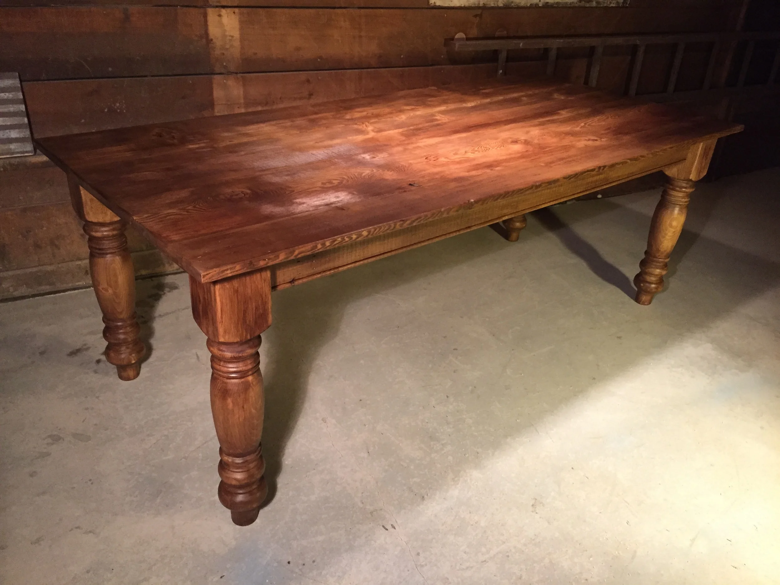 7' thick top English Pine table with weathred texture and custom oversized legs finished in Rugger Brown wax.