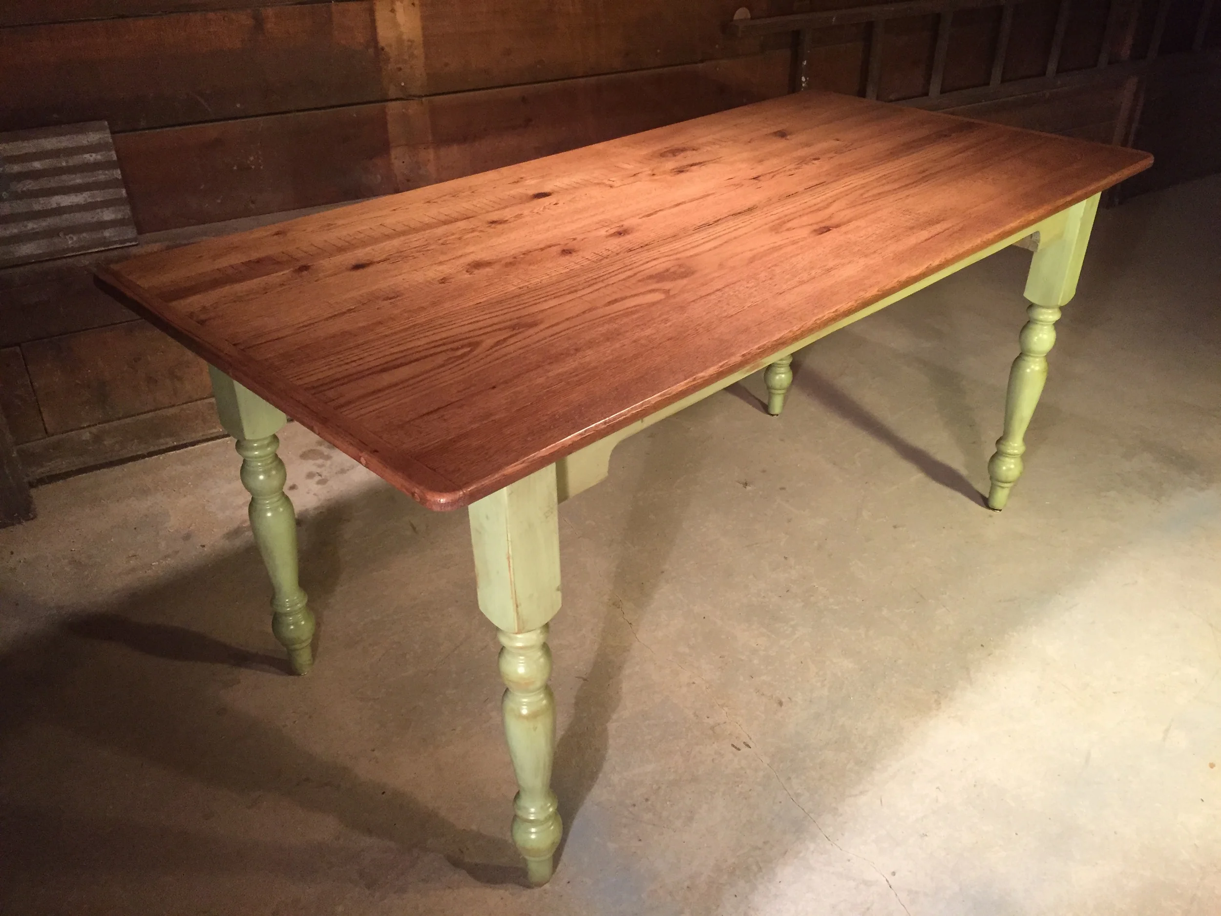 7' thin top dining table with American turned legs and custom cut apron finished with a Golden brown top and a glazed Beach Grass base 