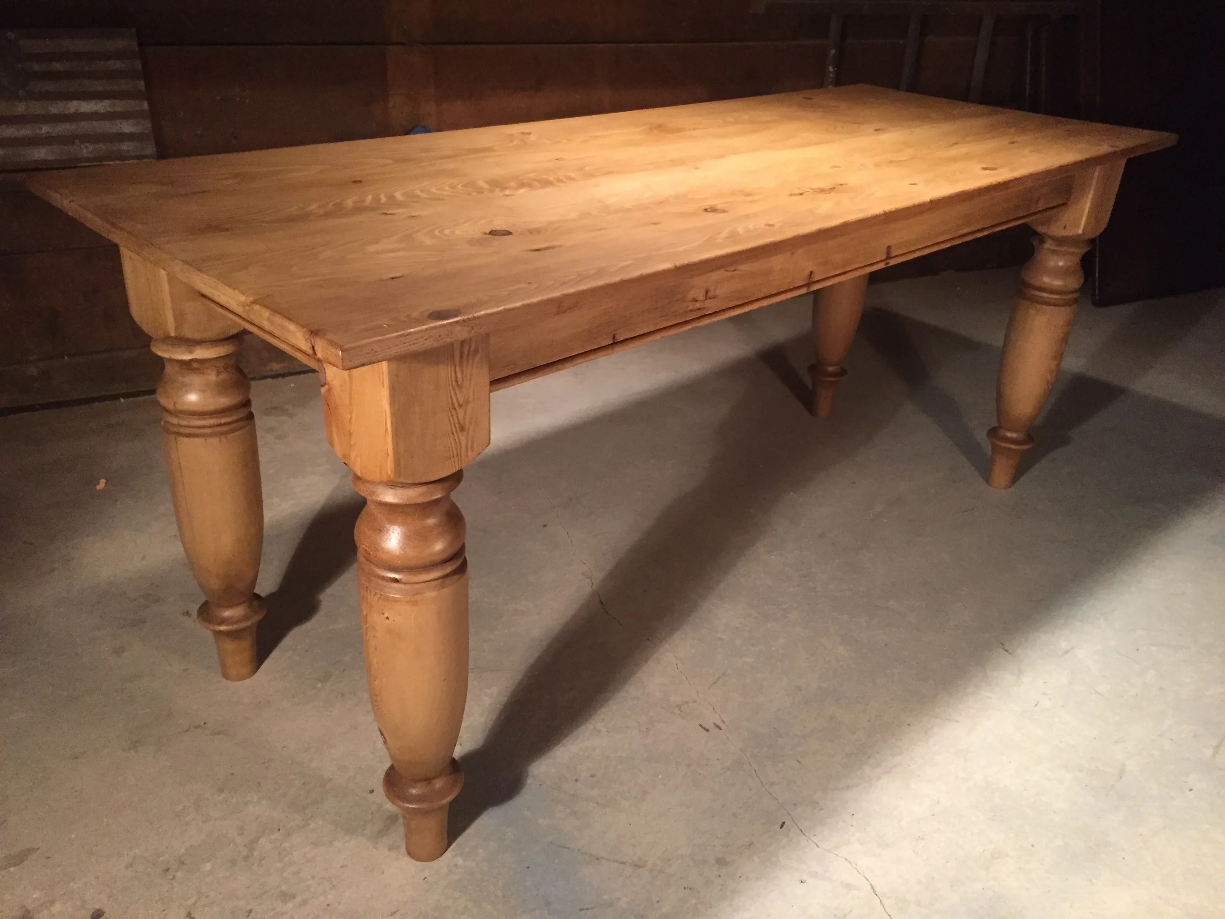 8' thin top English Pine dining table with custom oversized turned legs finished in Stripped Pine