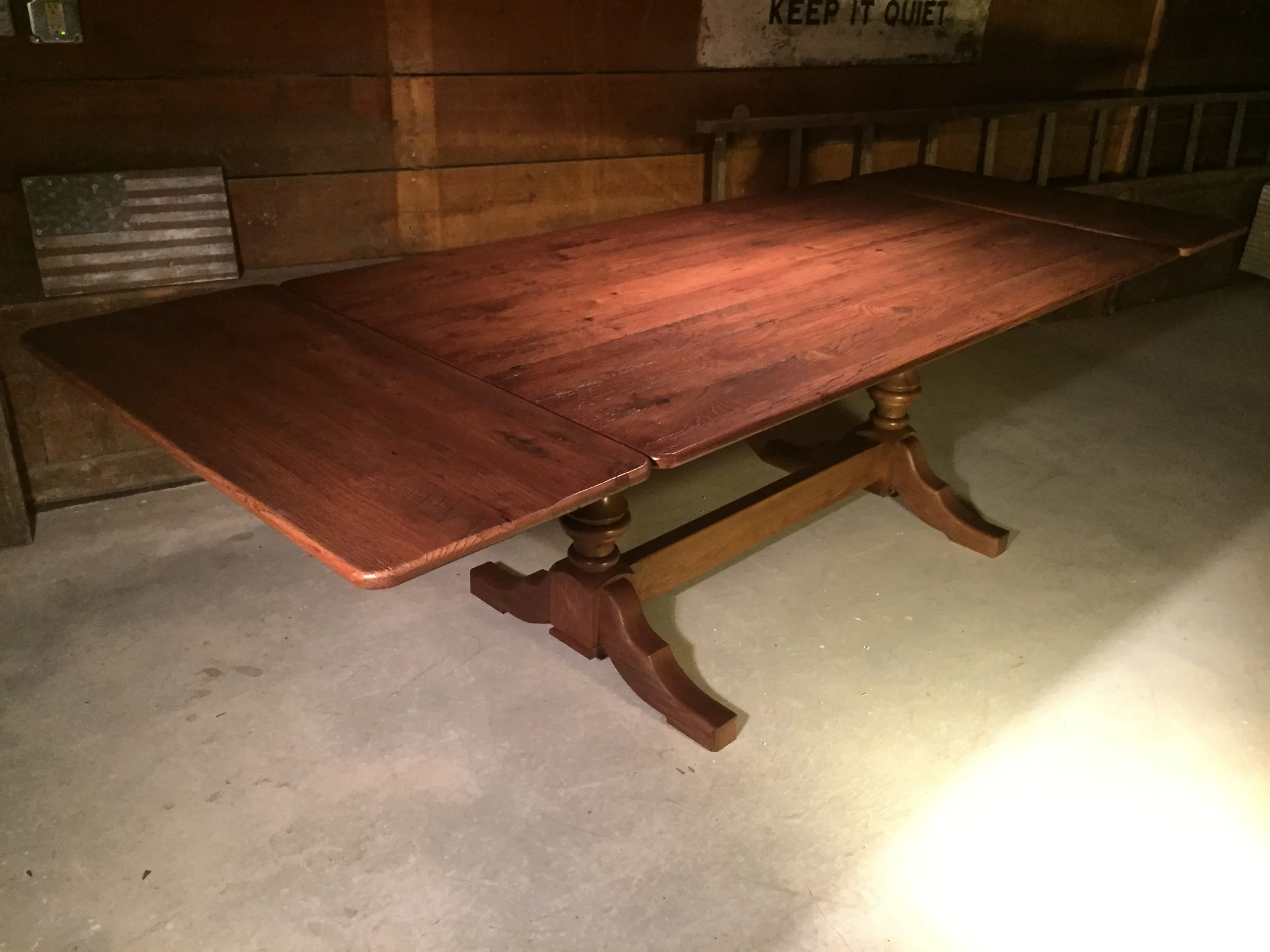 72"x38" thin top Barnwood dining table with double Elegant pedestal and two 18" extensions finished in Hazelnut