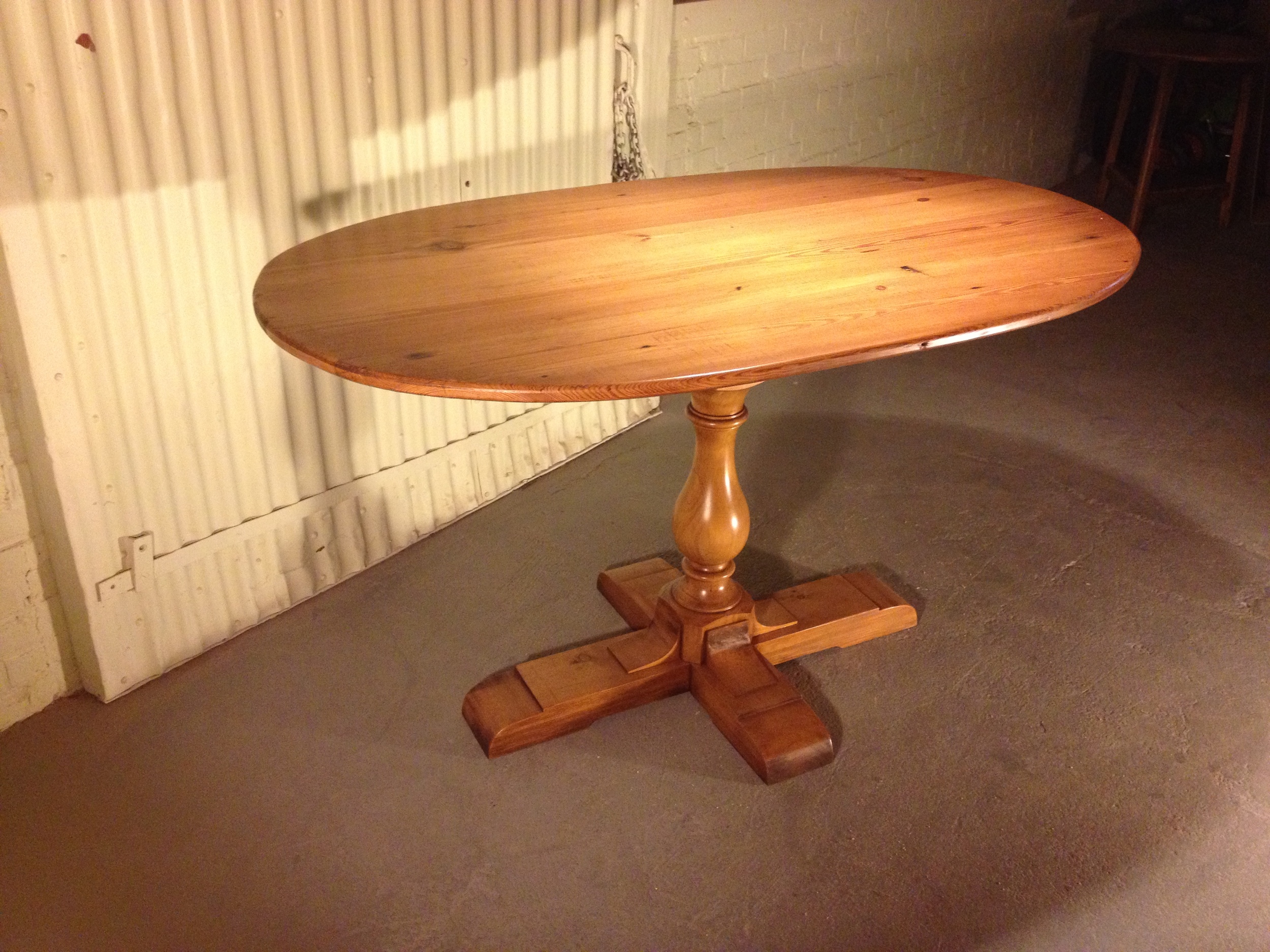 54" oval thin top table with Classic pedestal finished in Golden Brown