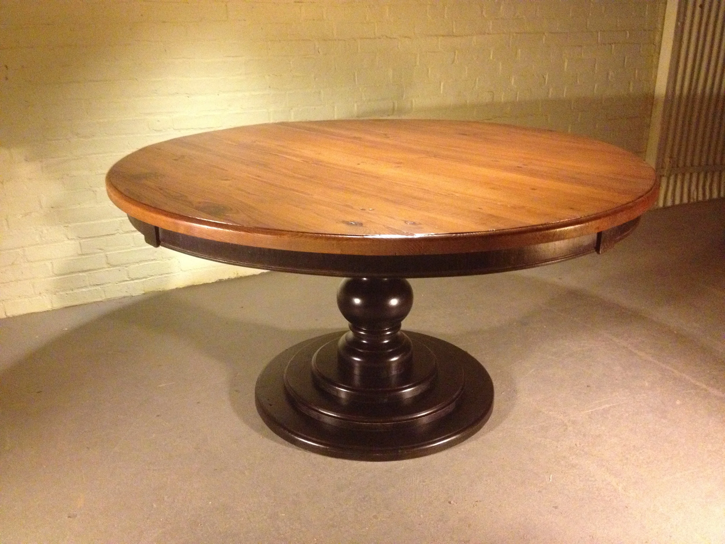 60" thick top Round dining table with custom curved apron and tiered Hosmer pedestal finished in Hazelnut with a black distressed base